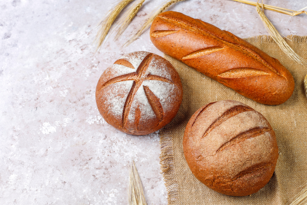 different kinds fresh bread as background 1